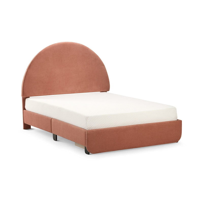 Terracotta pink upholstered twin bed with rounded headboard and white mattress on a modern fabric platform frame
