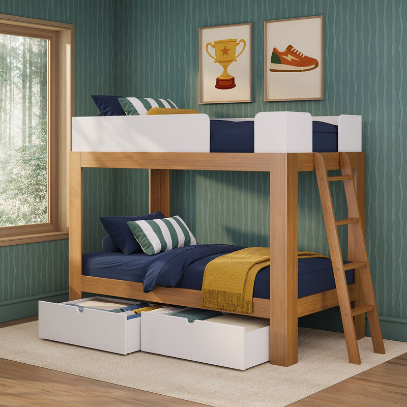 Wooden twin loft bunk bed with ladder, navy bedding, green-and-white striped pillows, mustard throw and under-bed storage drawers against teal textured wallpaper with framed trophy and sneaker wall art in a bright kids' bedroom