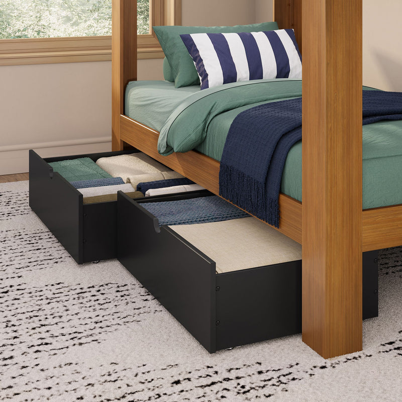 Wooden four-poster bed with under-bed storage drawers, green bedding, navy-and-white striped pillow and navy throw.