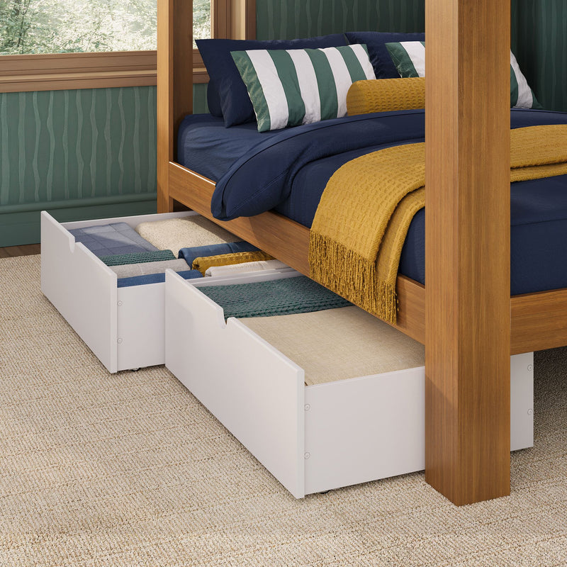 Wooden four-poster bed with navy bedding, green-and-white striped pillows and mustard throw, two white underbed storage drawers pulled out on carpet