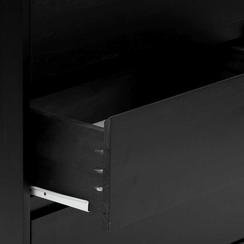 Close-up of black wooden drawer with dovetail joints and white metal slide, matte-finish dresser detail