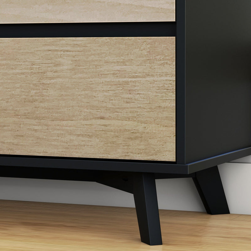 Close-up of modern dresser showing light oak veneer drawers, matte black metal frame and angled legs on hardwood floor