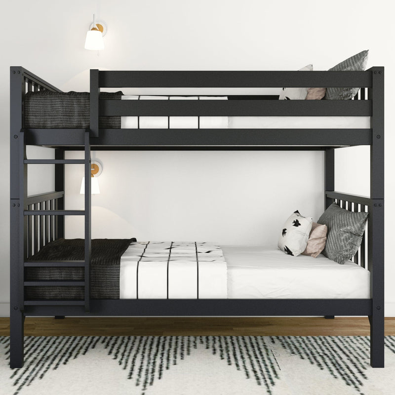 Black twin-over-full bunk bed with ladder, white bedding and patterned pillows in a minimalist bedroom with wall sconces