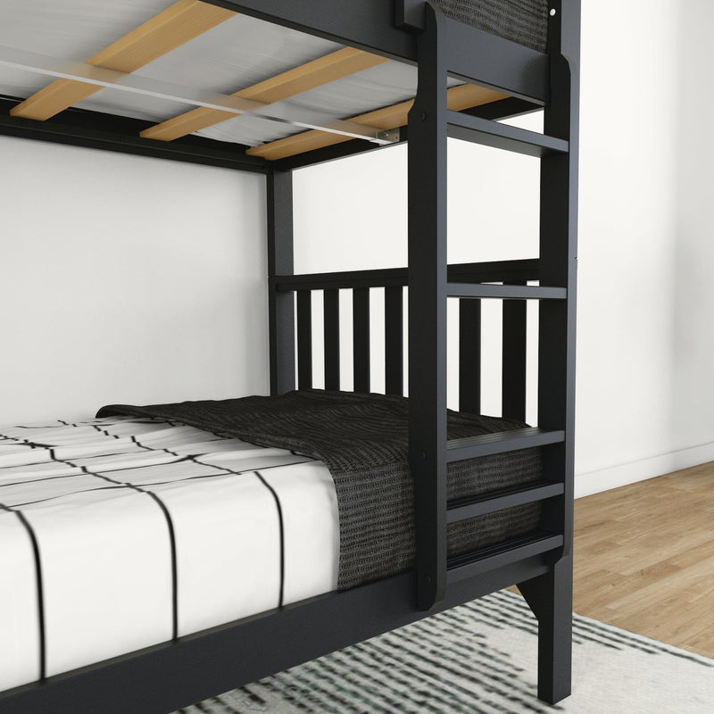 Black metal bunk bed frame with ladder and wooden slats, twin mattress with white striped sheets and charcoal knit blanket on hardwood floor with area rug