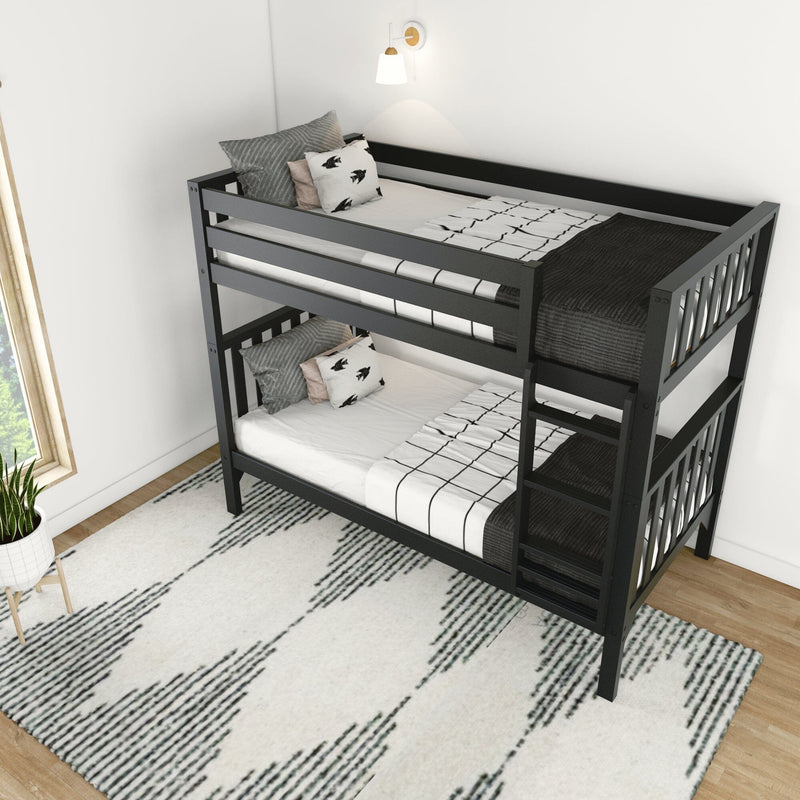 Modern black wooden bunk bed with ladder, monochrome grid bedding and decorative pillows under a wall sconce in a minimalist white bedroom with patterned rug and natural window light