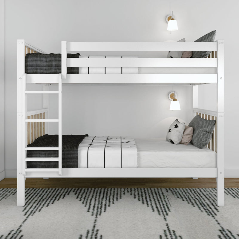 White wooden bunk bed with ladder in a modern minimalist bedroom, white and black striped bedding, decorative pillows, wall-mounted sconces, and patterned area rug