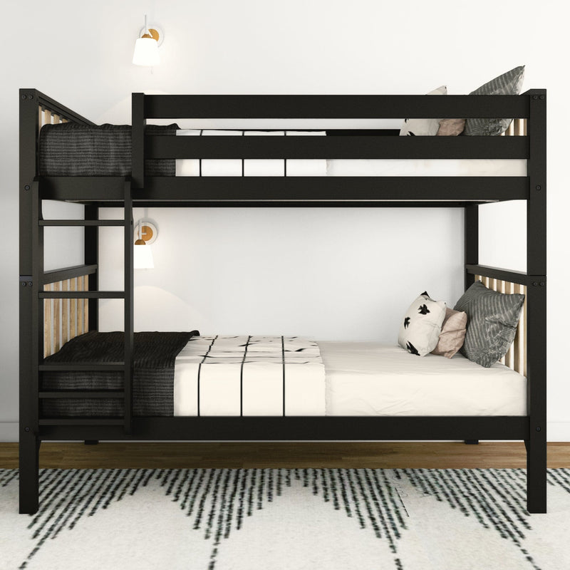 Space-saving modern black metal bunk bed with ladder, monochrome bedding and decorative pillows in a minimalist bedroom with wall sconces and patterned rug