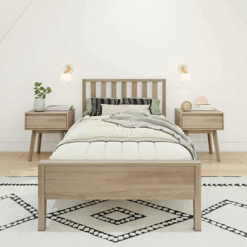 Minimalist Scandinavian bedroom with natural wood bed frame, matching nightstands, neutral bedding, patterned rug, wall sconces and green plant