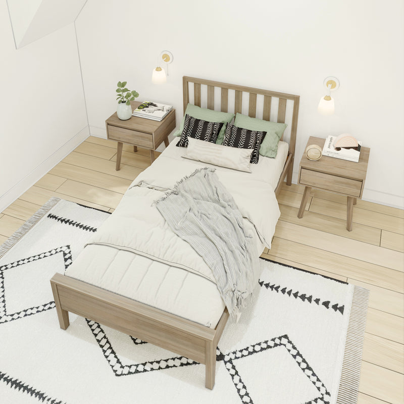 Minimalist Scandinavian bedroom with wooden platform bed, matching mid-century nightstands, green pillows, wall sconces and patterned black-and-white rug on light wood floor