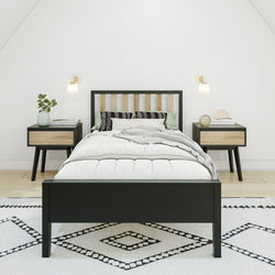 Modern Scandinavian bedroom with minimalist decor, featuring a sleek black bed frame, natural wood nightstands, and geometric patterned rug.