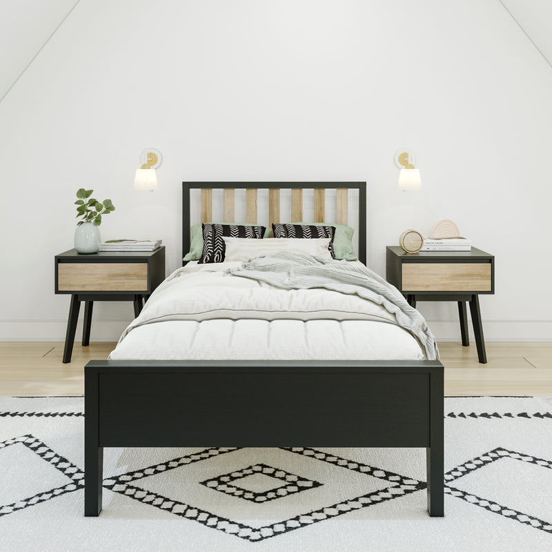 Modern minimalist Scandinavian bedroom with black wood bed frame, white bedding, patterned rug, matching wood nightstands, wall sconces and potted plant