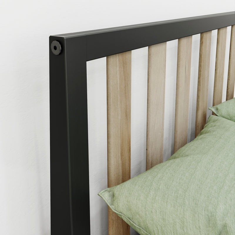 Close-up of modern slatted wood headboard with black metal frame and light wood slats, green bedding, minimalist bedroom decor