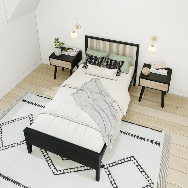 Modern minimalist bedroom interior with black wood bed frame, light wood flooring, patterned white rug, matching nightstands, wall sconces and green accent pillows