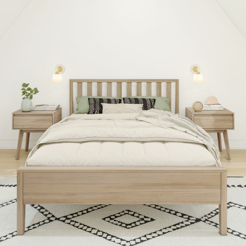 Minimalist bedroom with light wood bed frame, neutral linen bedding, green accent pillows, nightstands, wall sconces and patterned rug