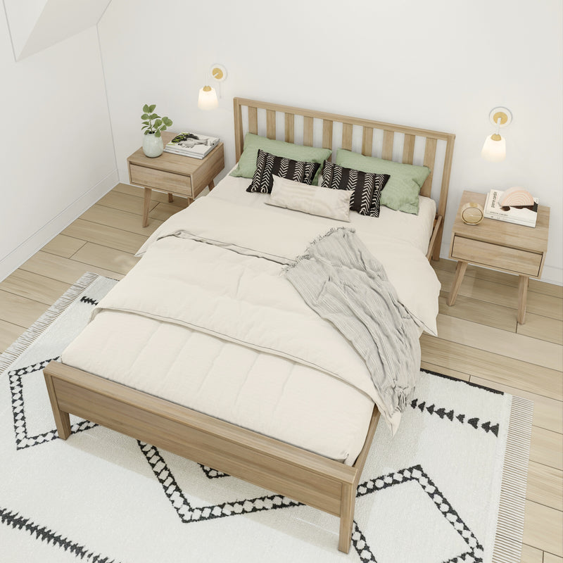 Scandinavian minimalist bedroom with light wood bed frame, neutral bedding, green and black patterned pillows, matching wooden nightstands, wall sconces and geometric rug