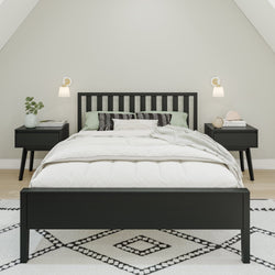 Modern bedroom with a black bed frame, stylish side tables, and ambient lighting.
