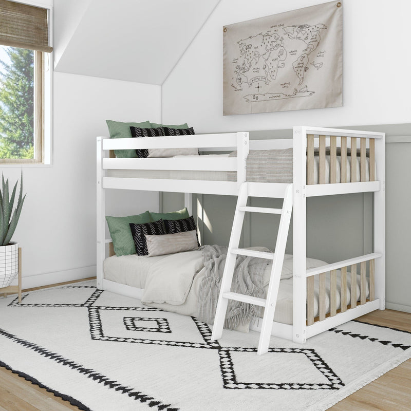 Modern white wooden twin-over-twin bunk bed with ladder in bright kids' bedroom — neutral linens, green accent pillows, black-and-white geometric rug, map wall art and large window