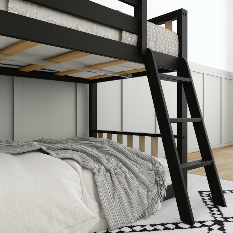 Black metal loft bunk bed with ladder, wooden slats and gray striped throw on neutral bedding in a modern bedroom
