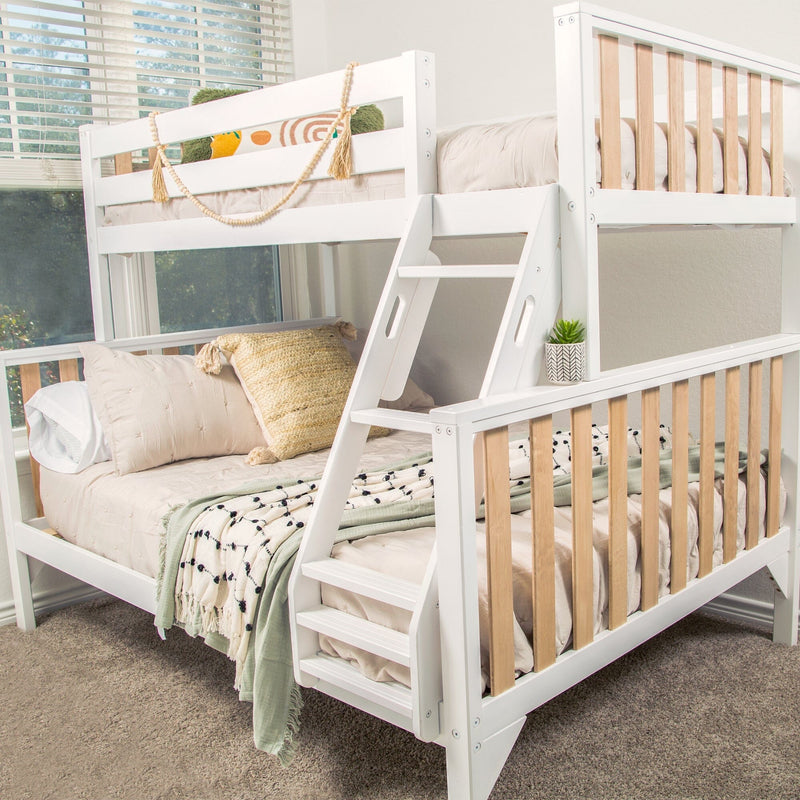 White wooden twin-over-full bunk bed with angled ladder, natural wood slats and beige bedding in a modern kids' bedroom
