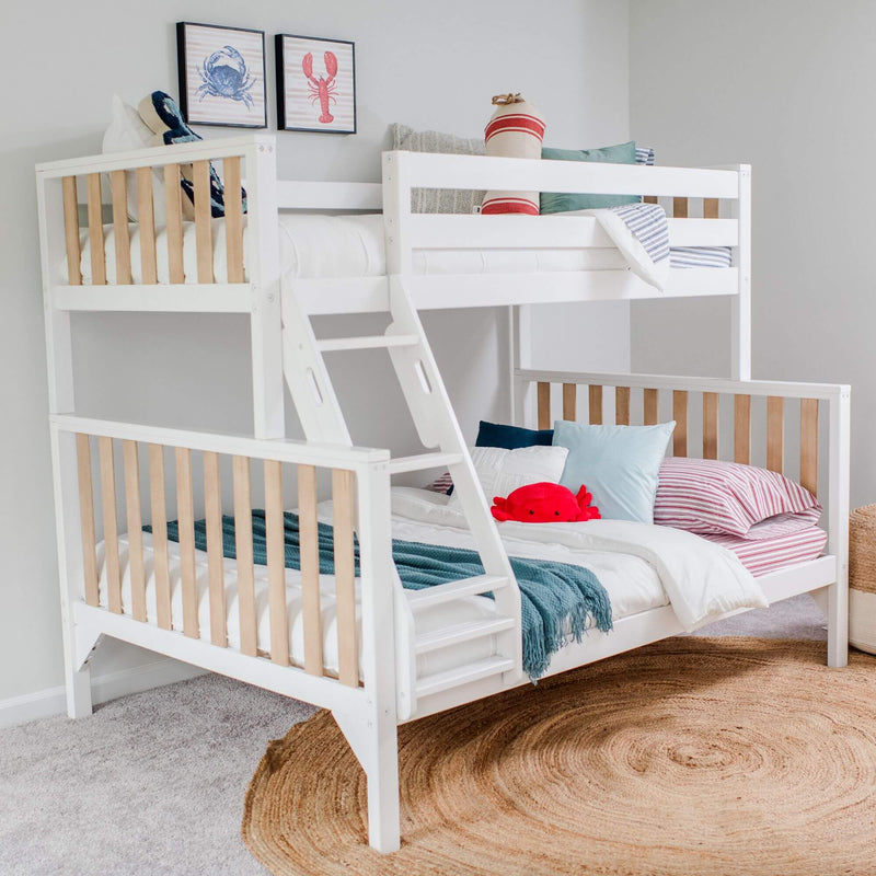 White wooden kids bunk bed with ladder in coastal bedroom, striped bedding, sea-themed pillows, red crab plush and framed lobster and crab wall art