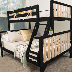 Black wooden bunk bed with integrated ladder and natural wood slat accents in a modern kids' bedroom, cozy neutral bedding and decorative pillows, potted succulent and window light on carpeted floor