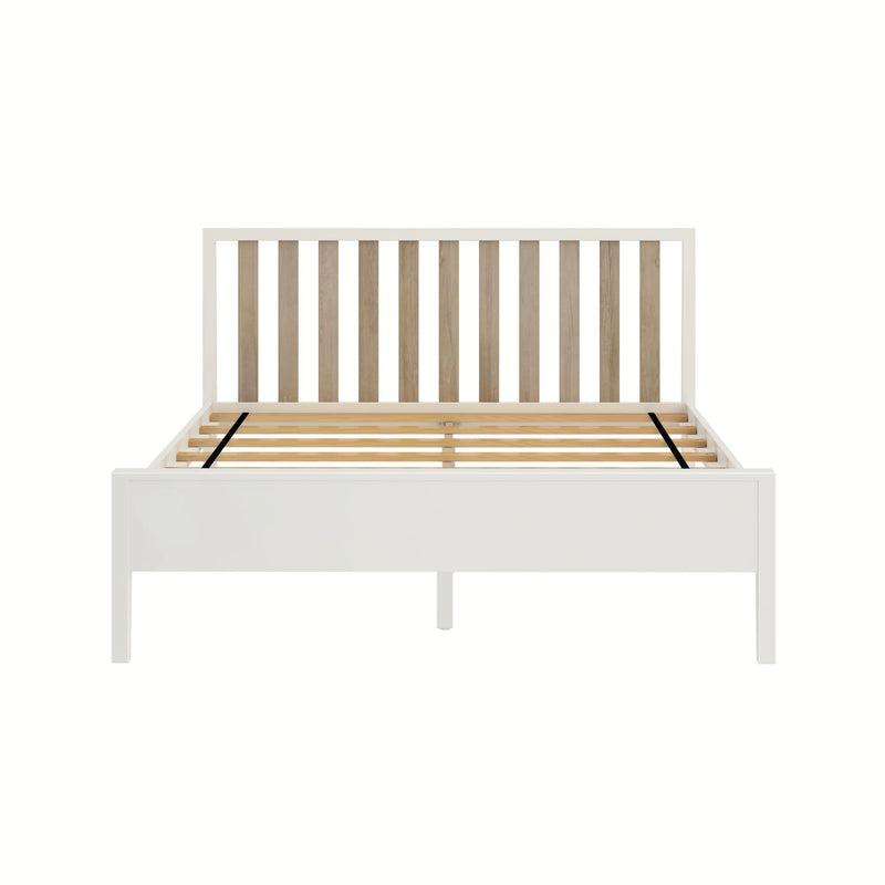 White wooden platform bed frame with natural oak slatted headboard and wooden slat support base on white background
