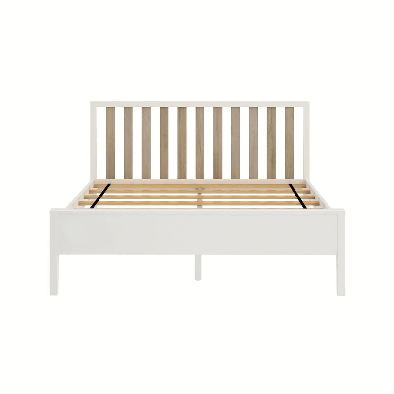 White wooden platform bed frame with natural oak slatted headboard and wooden slat support base on white background