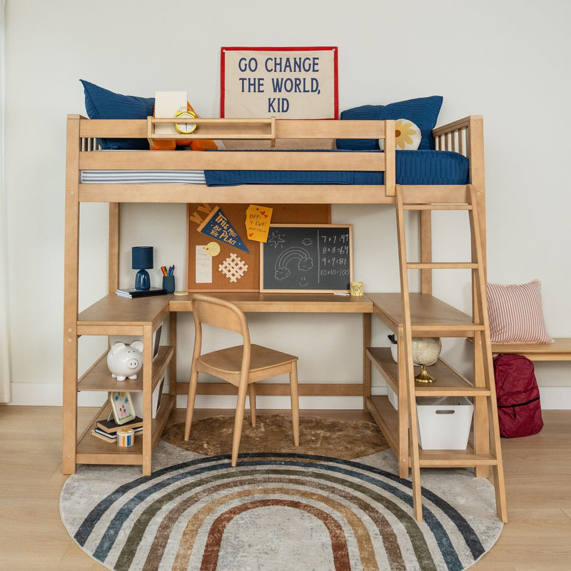 Wooden loft bed with built-in desk and ladder in a children's bedroom, navy blue bedding and pillows, study nook with corkboard and chalkboard, globe and piggy bank on shelves, and a motivational wall sign reading "Go Change The World, Kid