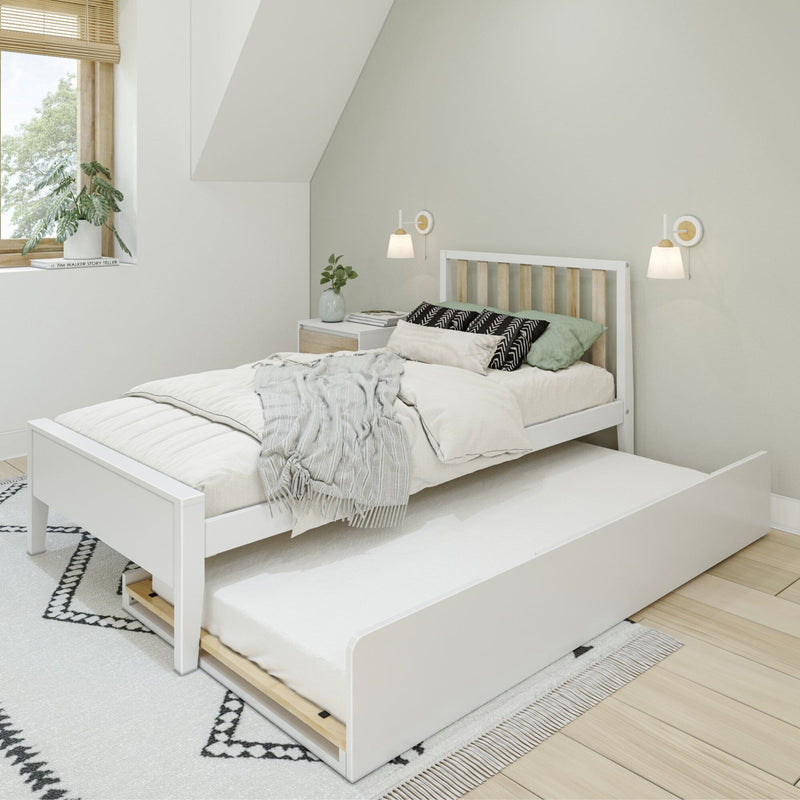 Minimalist Scandinavian bedroom with white wooden trundle bed, neutral layered bedding, wall sconces, potted plant and natural light