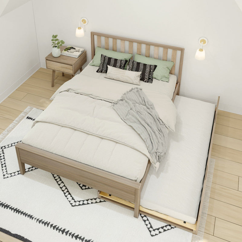 Scandinavian bedroom with wooden platform bed and trundle drawer, neutral bedding and textured throw, green accent pillows, nightstand with plant and wall sconces