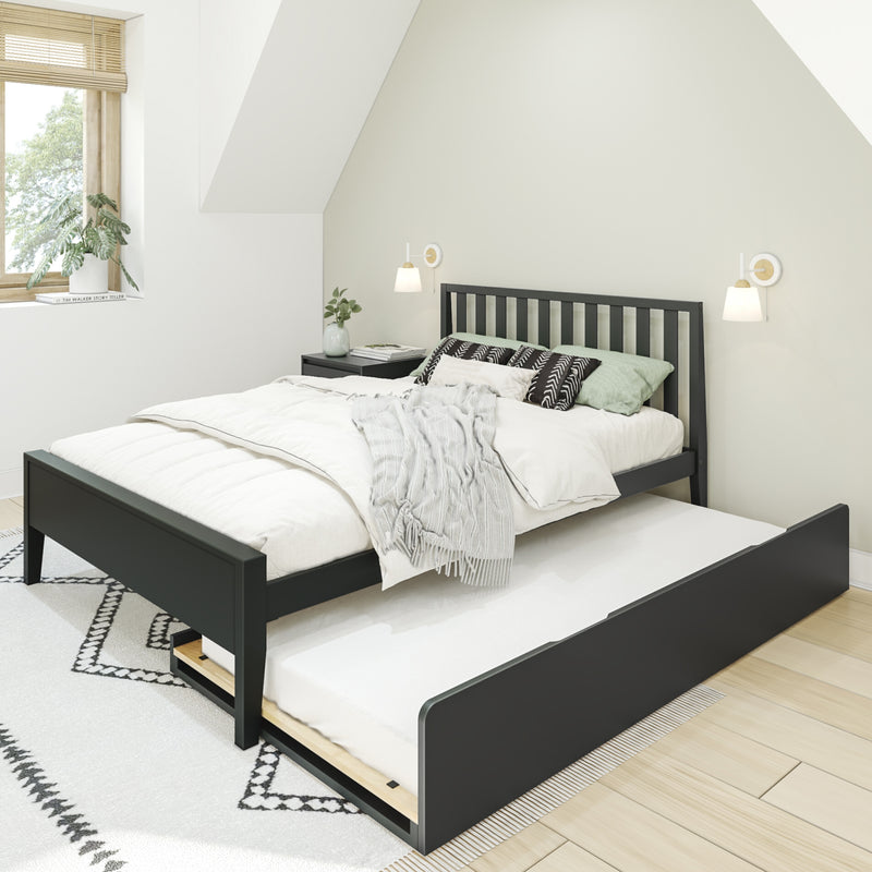 Scandinavian-style minimalist bedroom with black wooden bed frame and trundle, white bedding, patterned pillows, wall sconces, window blinds and potted plant