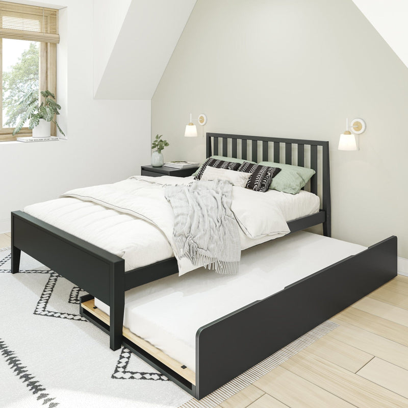 Scandinavian-style minimalist bedroom with black wooden bed frame and trundle, white bedding, patterned pillows, wall sconces, window blinds and potted plant