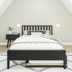 Modern bedroom interior with a black bed frame, white bedding, and a matching nightstand.