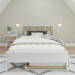 Modern bedroom with minimalist white bedframe, cozy bedding, wooden headboard, and elegant nightstand setup.
