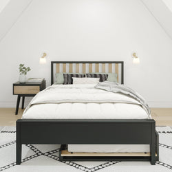 Modern bedroom with black and wood bed frame, white bedding, and matching nightstand in serene minimalist design.