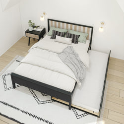 Modern bedroom with pull-out trundle bed and stylish decor, featuring a black wooden frame and cozy bedding.