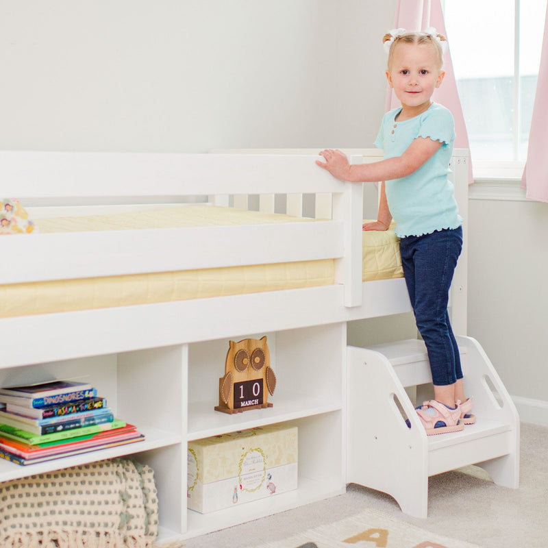 Toddler standing at white loft bed with built-in shelves and stairs in bright pastel nursery with kids' books and owl calendar
