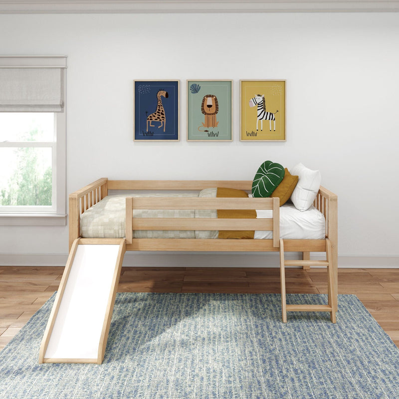 Wooden toddler bed with slide in bright kids bedroom, neutral bedding, green leaf pillow, blue rug and framed animal wall art — modern nursery decor