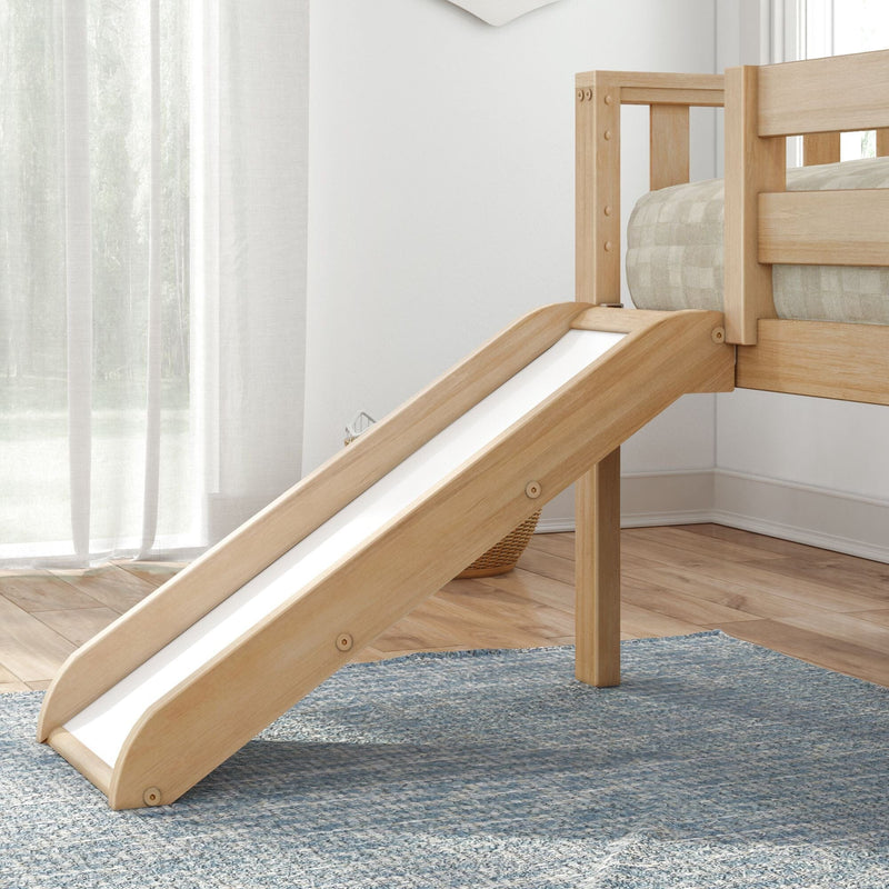 Light natural wood kids loft bed with slide, neutral bedding, sheer curtains and blue rug in a bright Scandinavian-style children's bedroom