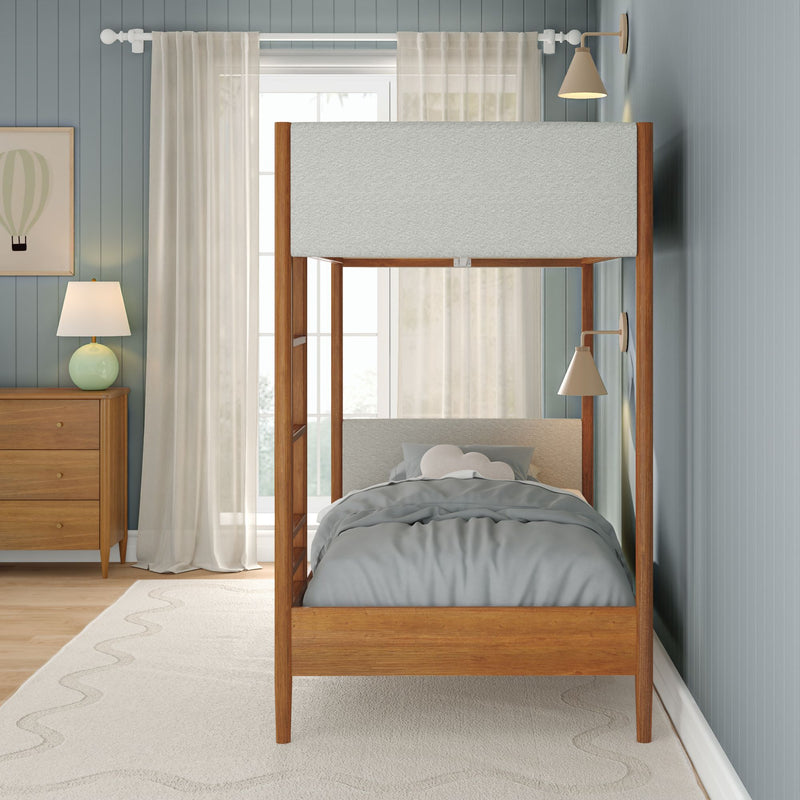Modern children's bedroom with wooden house-frame bunk bed, gray bedding and cloud pillow, pale blue shiplap walls, sheer curtains and bedside lamp