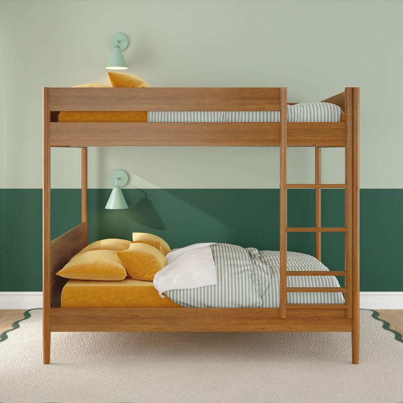 Wooden bunk bed in children's bedroom with mustard yellow bedding, striped sheets, ladder, green two-tone wall, mint wall sconces and carpeted floor.