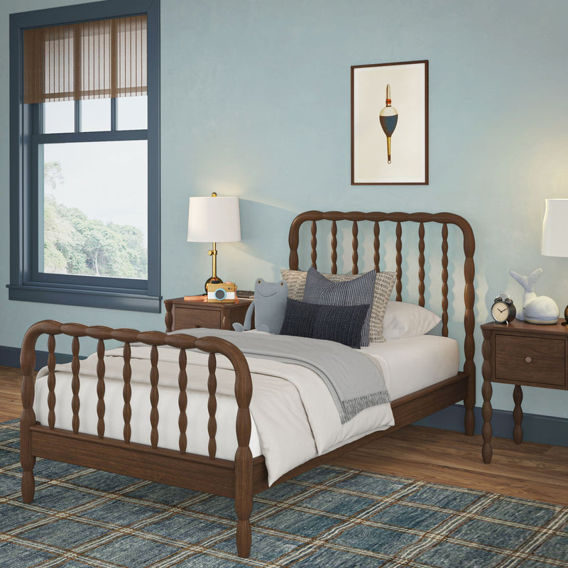 Cozy kids bedroom with wooden spindle bed, blue walls, plaid rug, matching nightstands and lamps, stuffed toys, window with brown blinds and nautical wall art