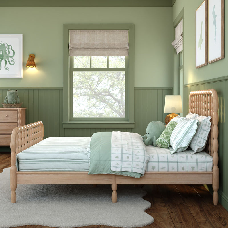 Mint-green children's bedroom with wooden twin bed, striped mint bedding, plush octopus toy, bedside lamp and dresser, window with roman shade and marine wall art