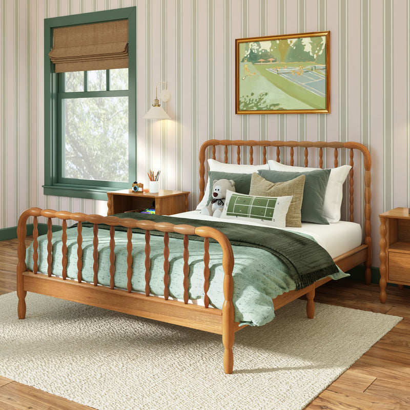 Cozy children's bedroom with wooden spindle bed, green bedding and pillows, striped wallpaper, framed art and green-trim window