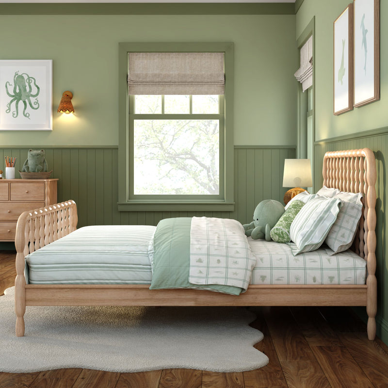 Cozy green kids' bedroom with light wood spindle bed, mint-striped bedding, plush octopus toy, octopus wall art, wooden dresser, woven wall sconce and roman shade window