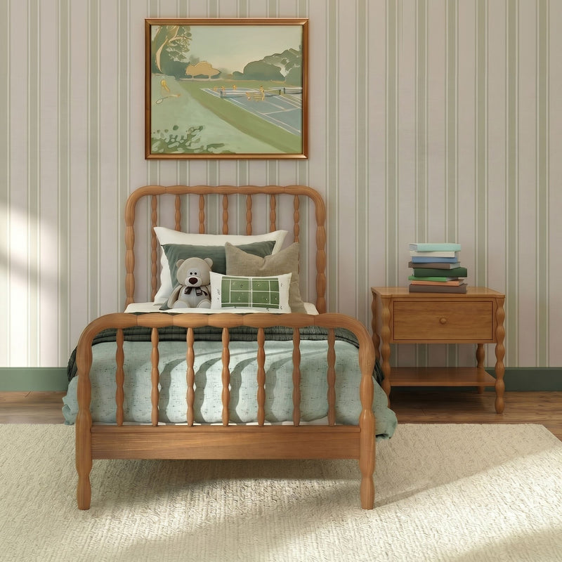 Cozy kids bedroom with wooden spindle bed, green bedding, teddy bear, striped wallpaper, framed art and bedside books