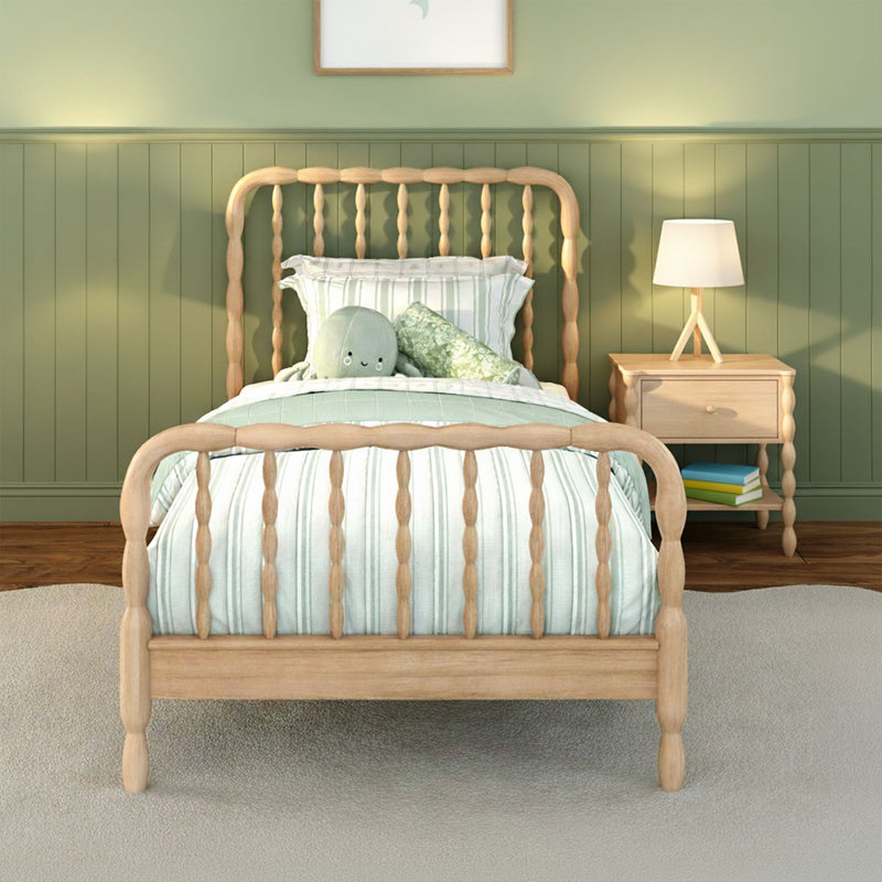 Children's bedroom with wooden spindle bed, mint green wainscoting, striped bedding, plush octopus toy and bedside lamp