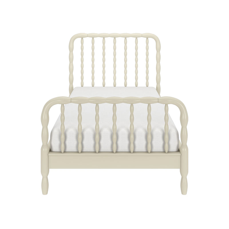 Cream-painted wooden spindle bed frame with turned spindle headboard and footboard, vintage farmhouse twin bed on white background