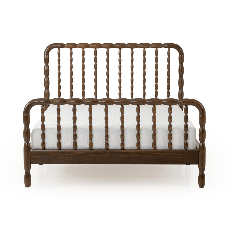 Dark walnut spindle bed frame with turned spindles and rounded headboard over white mattress, vintage farmhouse wooden bed product photo