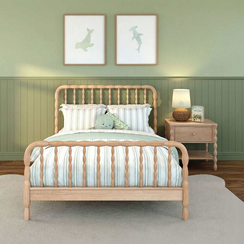 Cozy green nursery bedroom with wooden spindle bed, mint striped bedding, plush octopus pillow, coastal wall art and wicker nightstand lamp